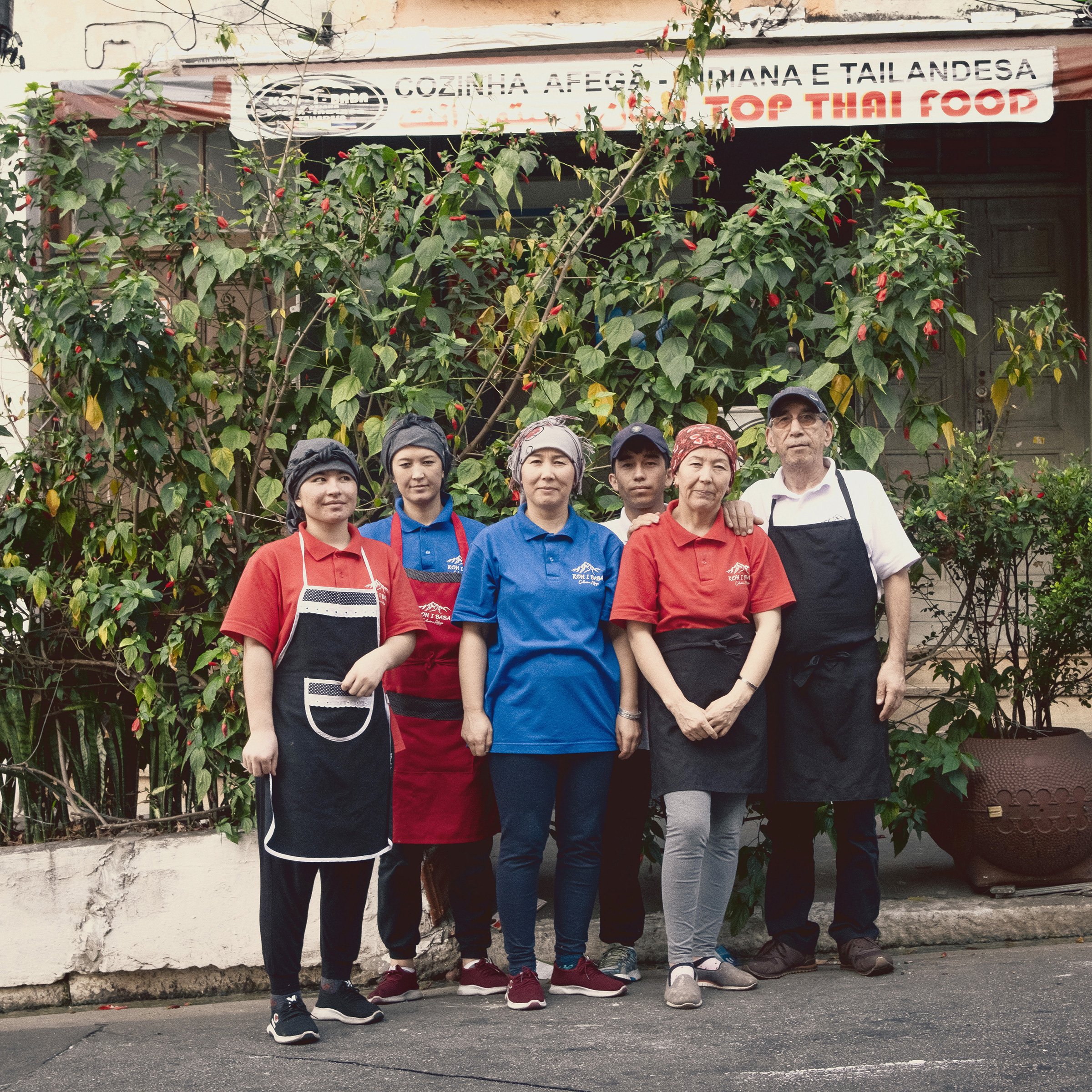 Ebrahimi's family in front of their restaurant in Brazil
