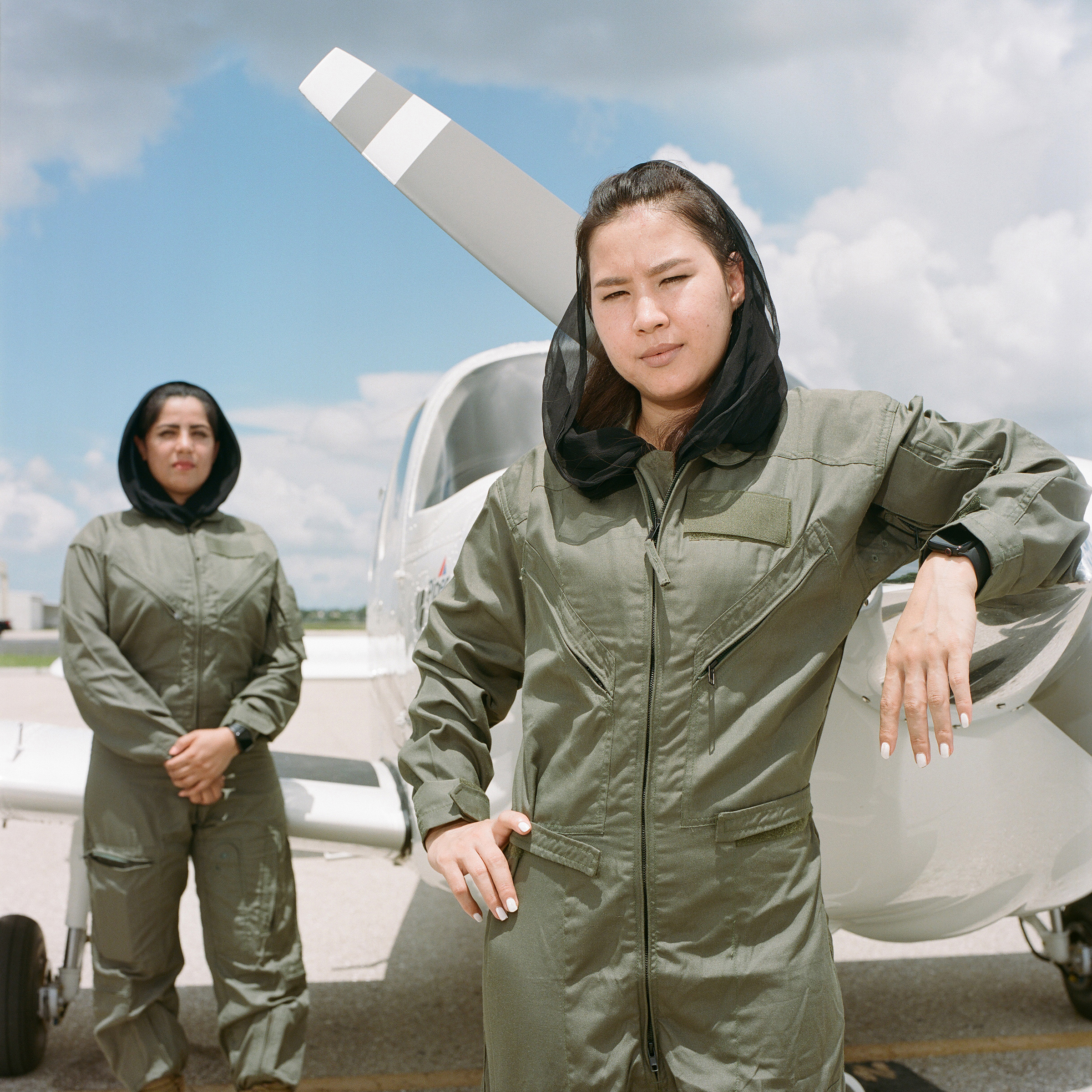 Hasina Najibi and Raihana Rahimi wear their old Afghan Air Force uniforms while visiting the Paragon pilot training school in Fort Myers, Fla.