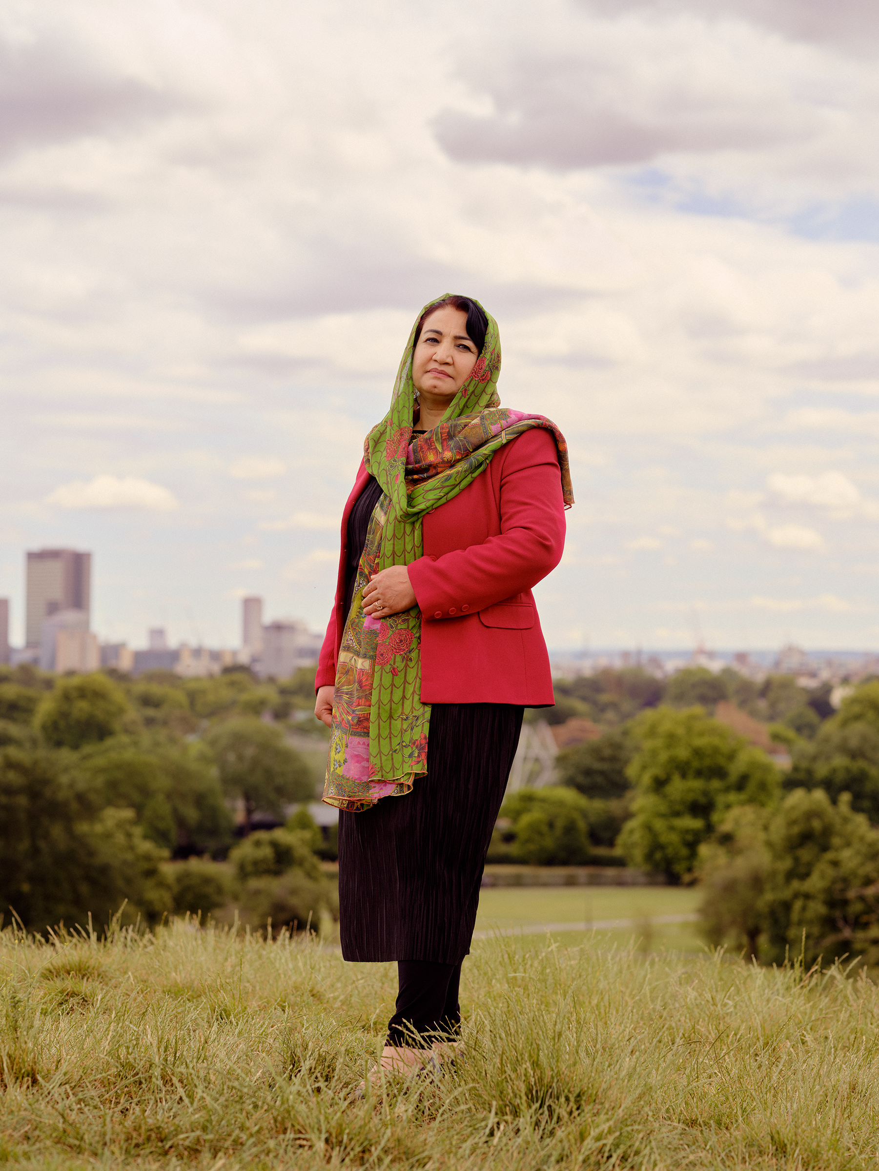Sahra Alizai stands in the park in London
