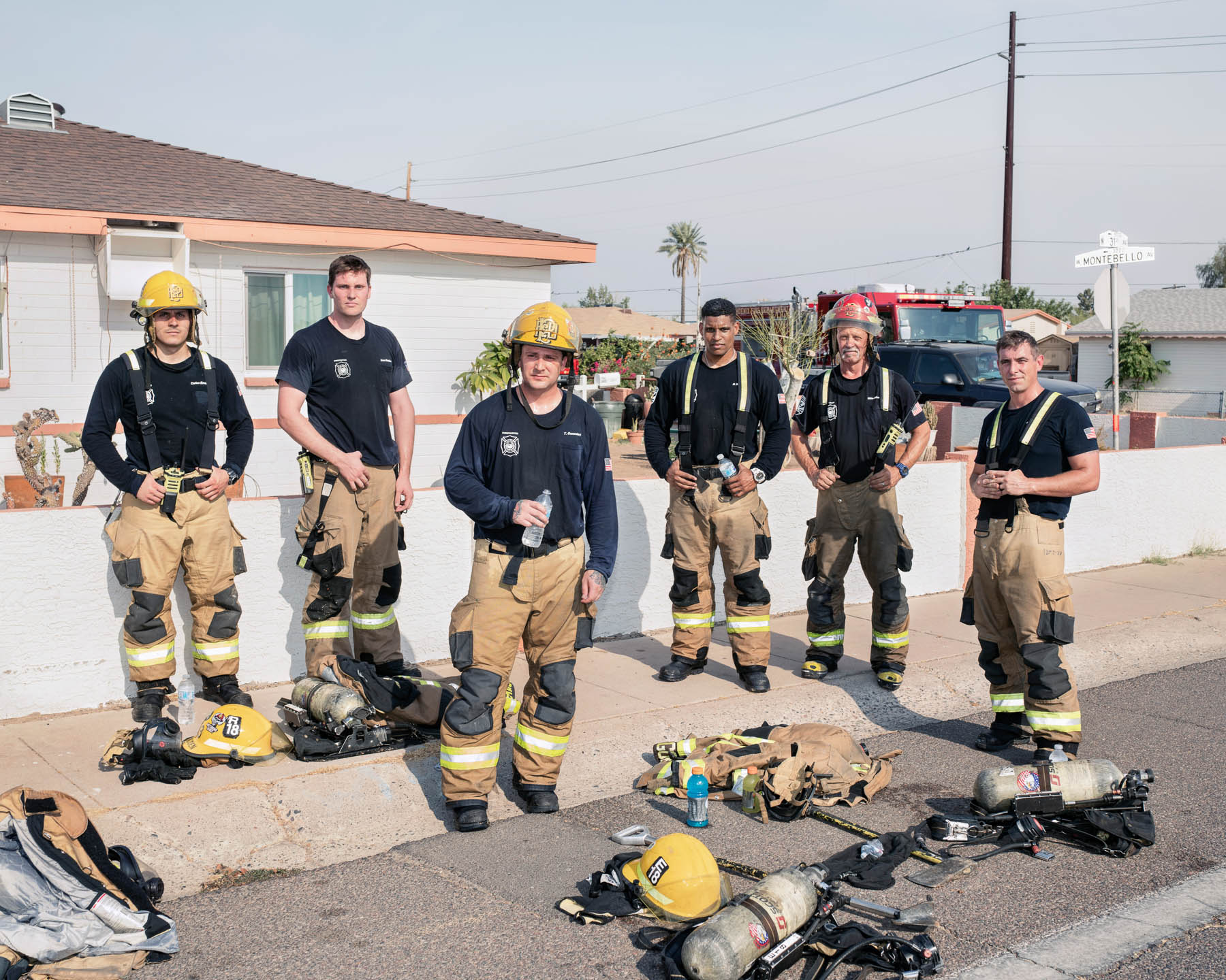 Firefighters from Phoenix Fire Department Station 18 stand for a portrait after a house fire on June 16, a day when the high was 115°F. “The heat definitely intensifies everything we do this time of year,” says Capt. Mike Adelman, second from right, who has spent 27 years with the department. The firefighters often perform activities similar to what they will encounter on site as a means of confronting the summer’s highest temperatures. They also work to control their breathing and pay strict attention to their situational awareness, so as not to expend energy they’ll need when calls come in. “What it comes down to is staying trained up, staying acclimated to the heat and understanding the environment that we live in and that we work in, and really just being able to overcome those obstacles,” says Richie Robnett, third from right. “A big part of this job is, you’ve got to get comfortable being uncomfortable.”