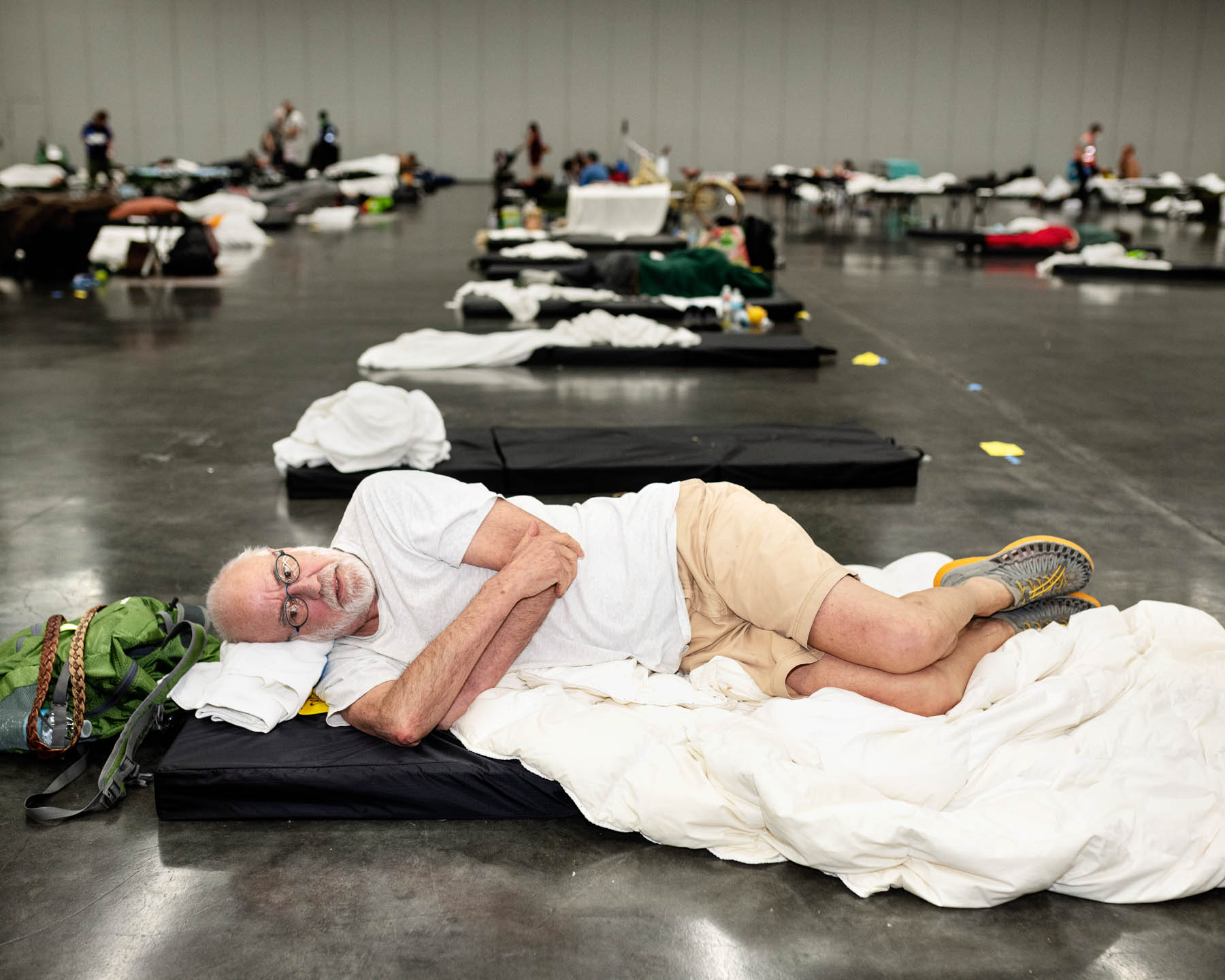 As temperatures soared in late June, Dennis Henry, a 71-year-old with a heart condition that makes breathing more difficult, left his “lovely old apartment house” that lacks air conditioning and hopped on a bus to the Oregon Convention Center, where a 24-hour cooling station was operating. “Yesterday, I thought I could make it through the day and the night, but I looked at the projections for today and the day after, and I decided I better get my tail down here and make sure I get a spot,” Henry said on June 27. “They’re very nice here... The food’s even good,” he adds. “They keep it slightly colder than it needs to be. I go out and warm up every once in a while for a little bit. Which is ridiculous! Isn’t it ironic?”