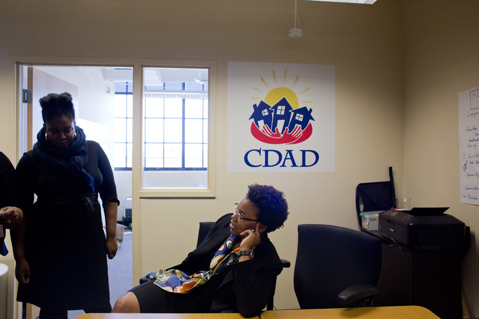 Sarida Scott (seated) discusses the Strategic Empowerment Initiative at the offices of Community Development Advocates of Detroit.