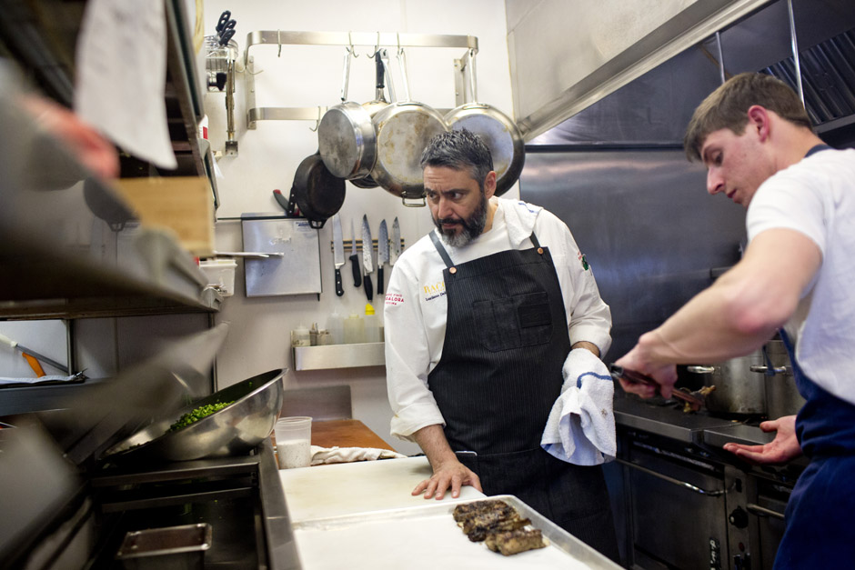 Luciano del Signore standing at the pass at Bacco, his iconic Italian restaurant in Southfield.